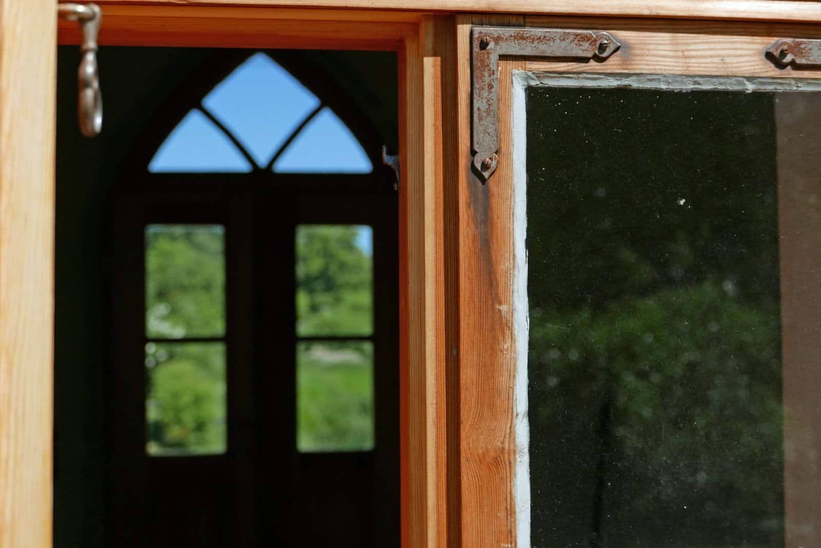 Wooden window frame with glass pane, showcasing craftsmanship and rustic design. Perfect for enhanci.